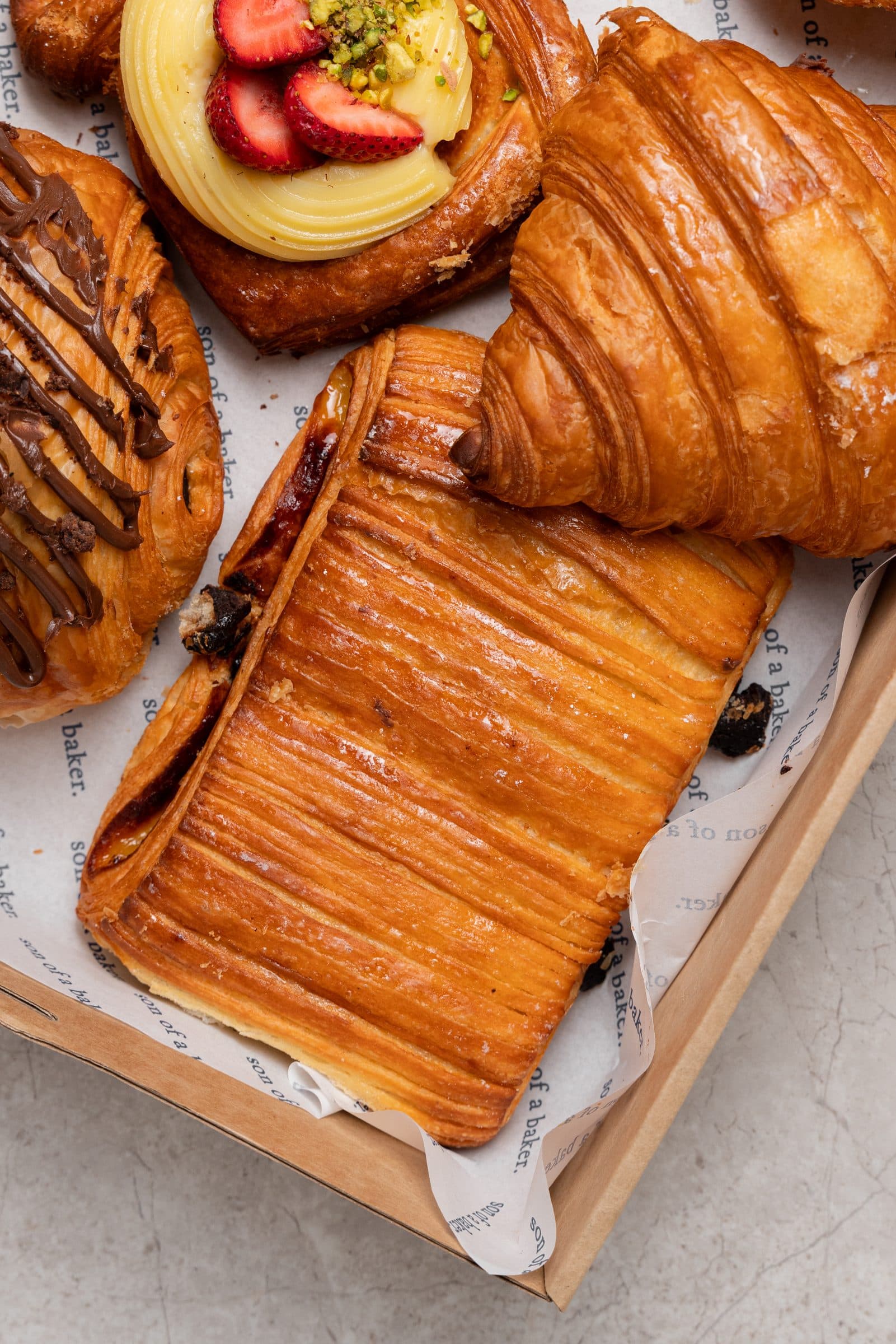 A son of a baker box of pastries