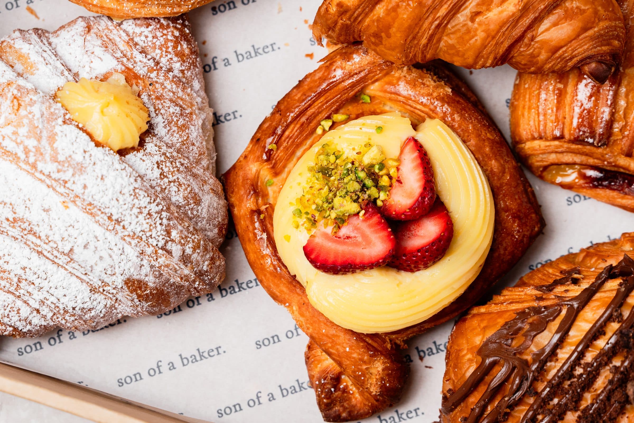A larger son of a baker box of danishes and croissants
