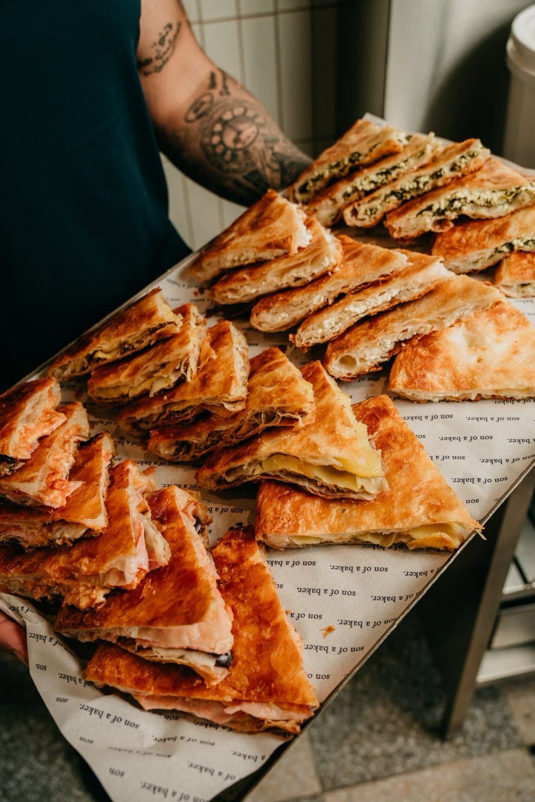 A tray of sliced whole bureks on son of a baker paper