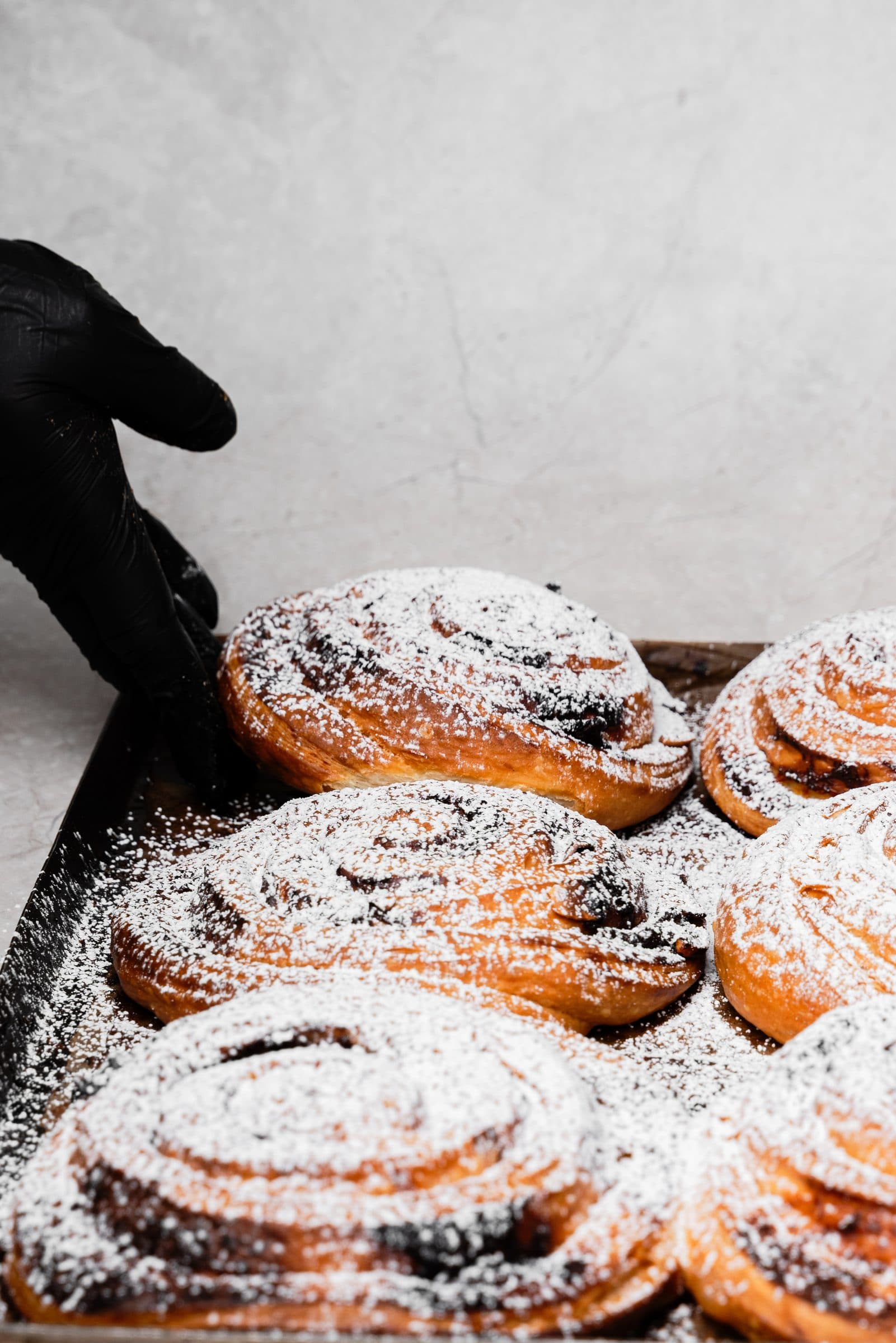 Scrolls being dusted with icing sugar